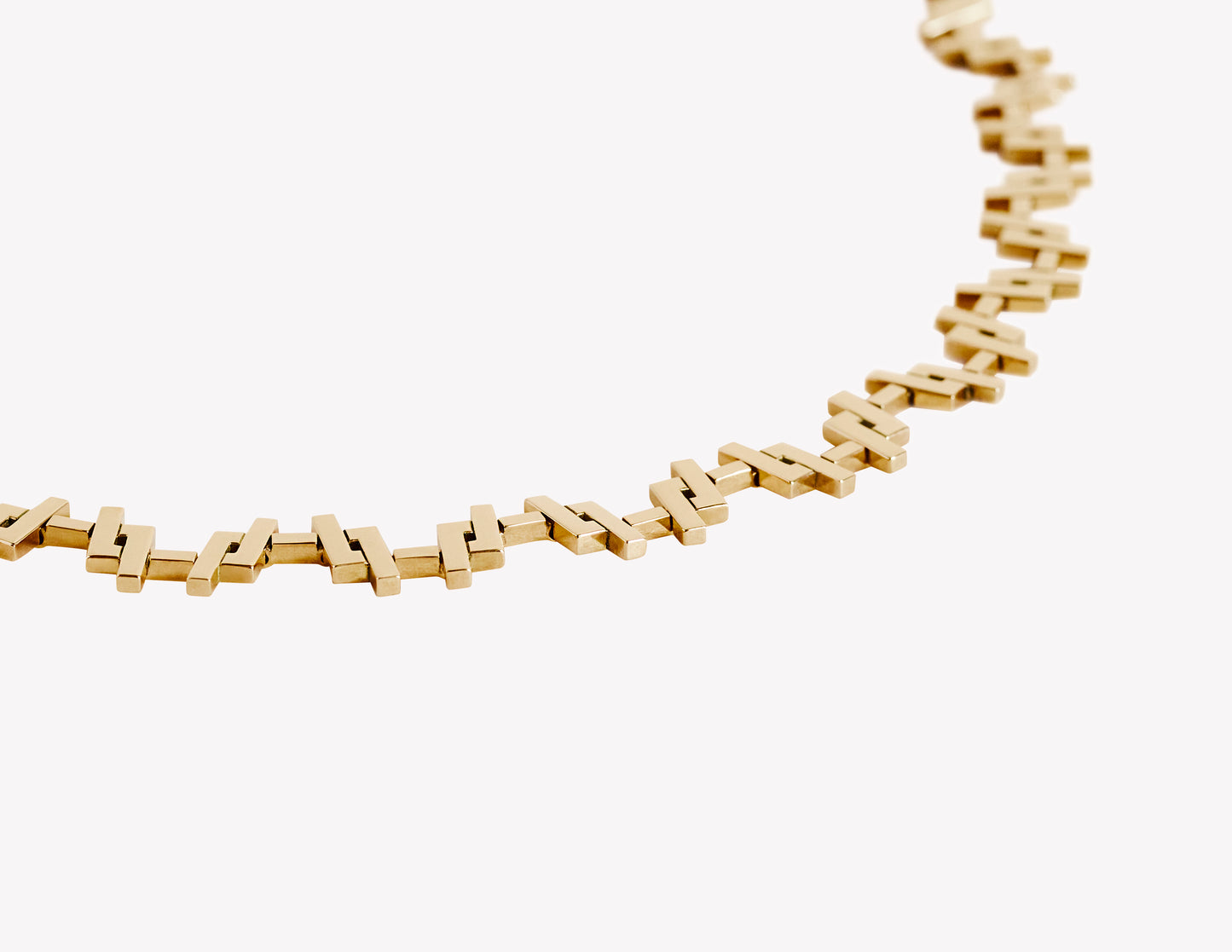 close up of an 18k Gold chain link necklace on a white background