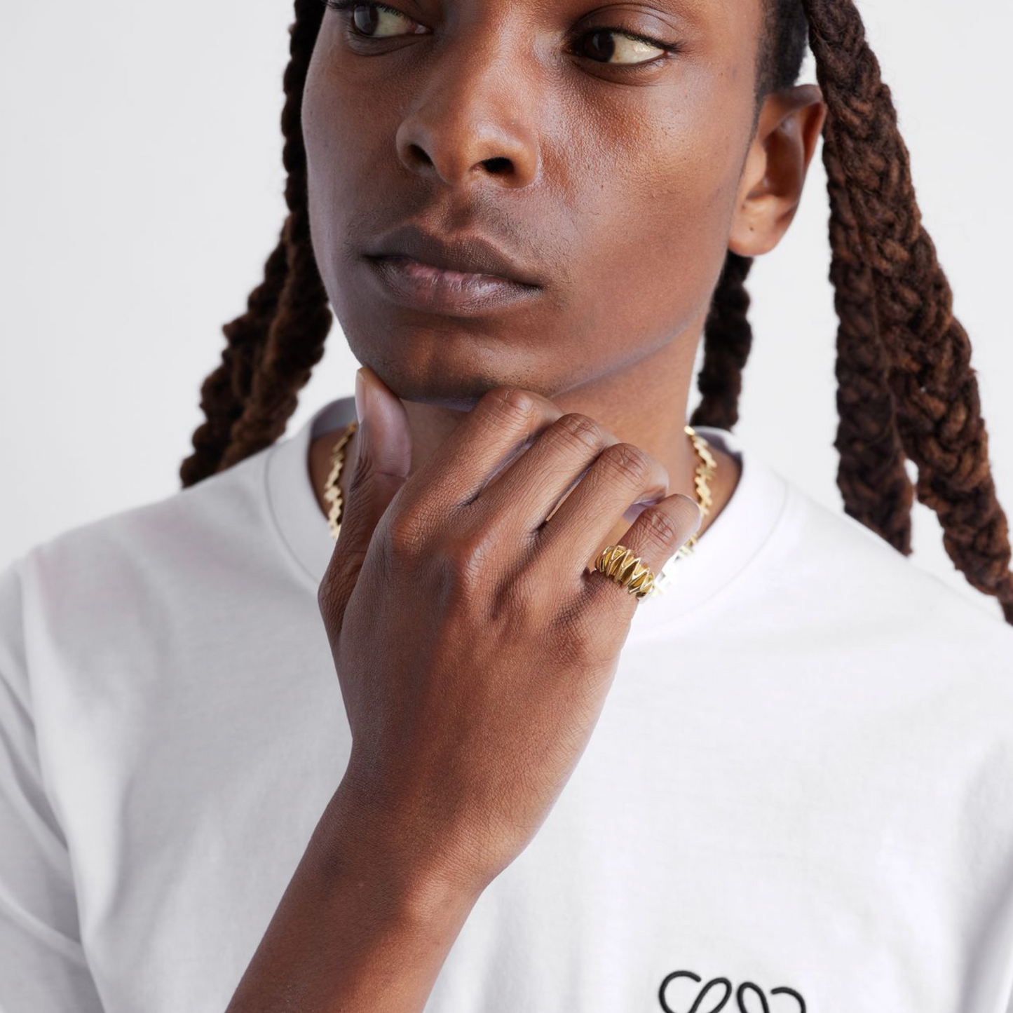 a male model wearing a gold textured pinky ring