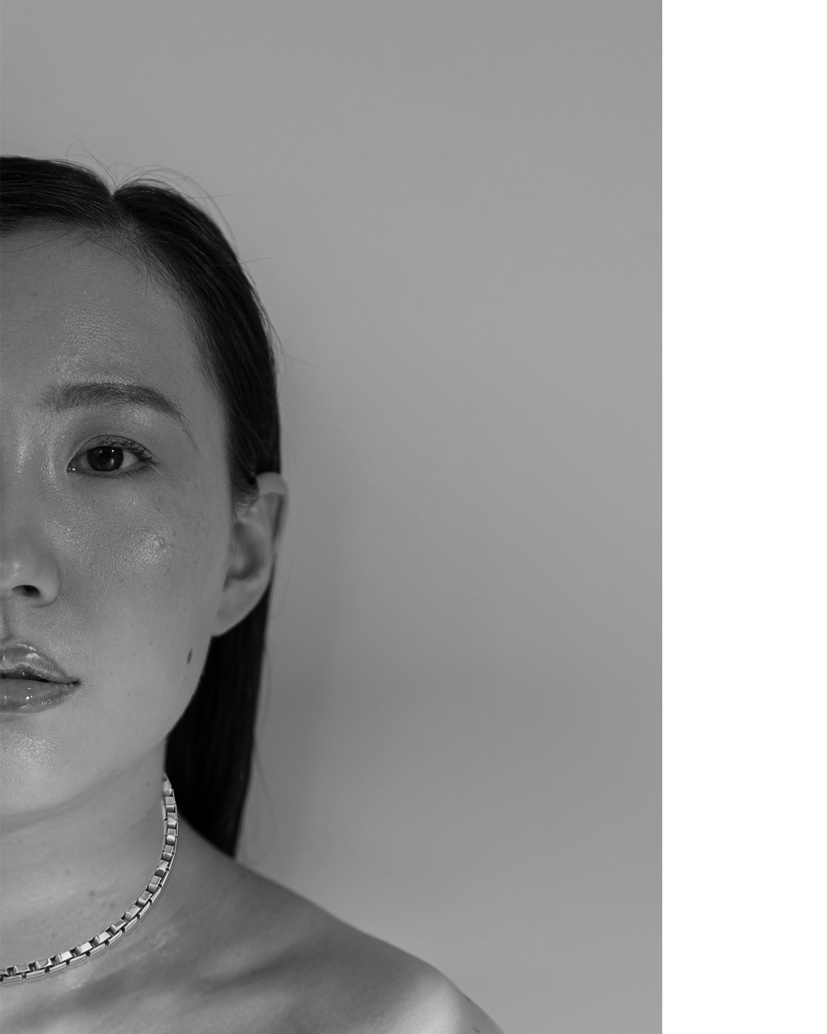 black and white model image with yellow gold empire strand necklace