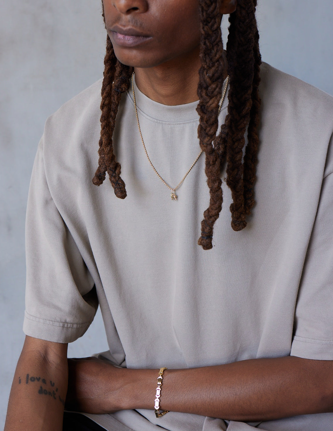 A model shot of a gold bracelet with a chain of linked half-moon crescent shapes, crafted in an Art Deco style.