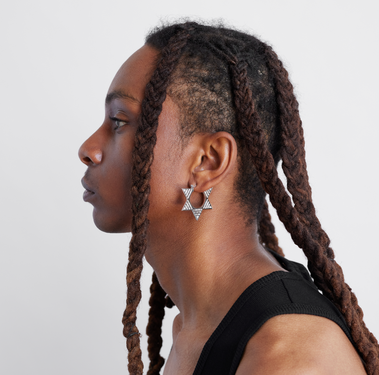 male model wearing double sided white gold and diamond hoops