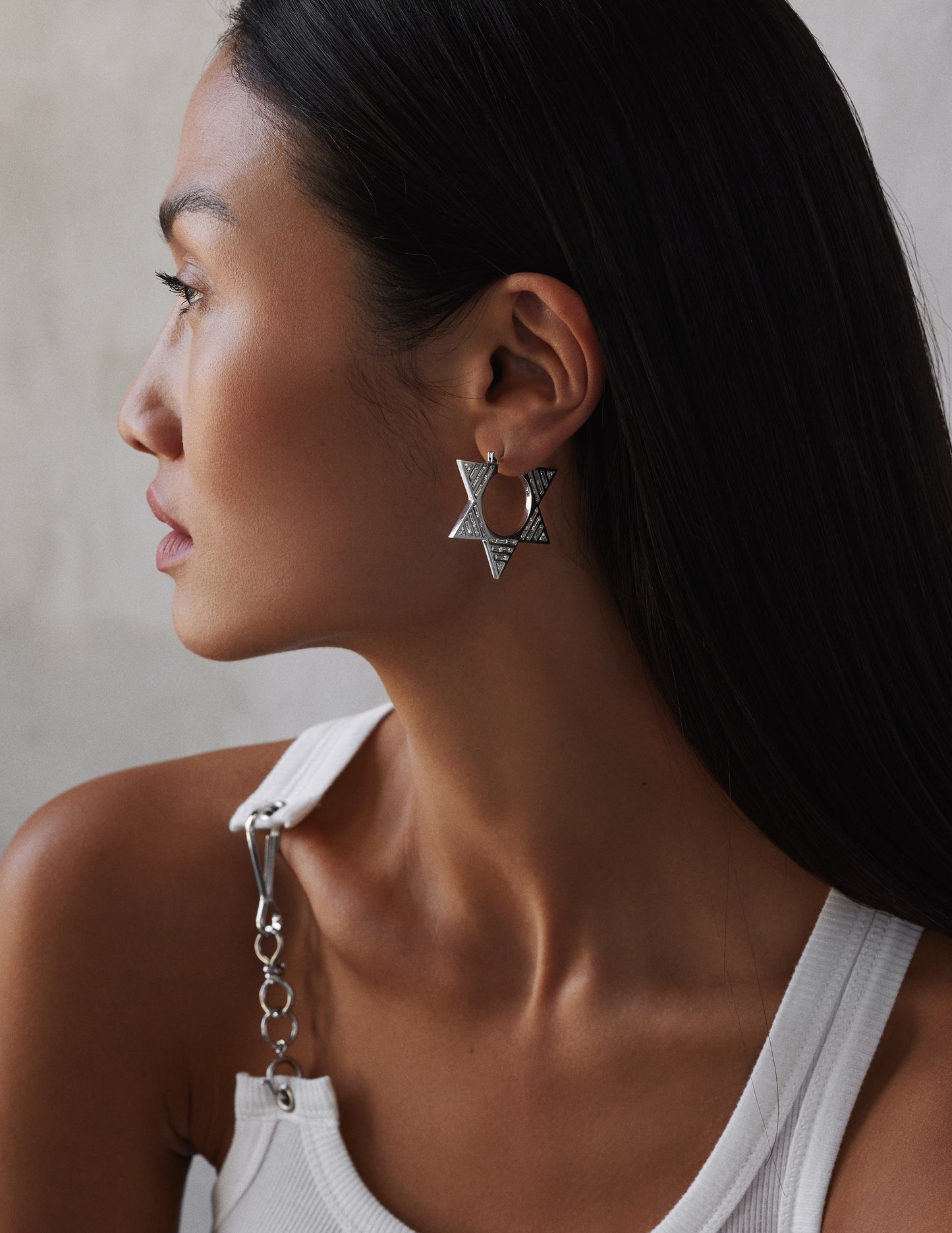 female model wearing double sided white gold hoops set with baguette diamonds