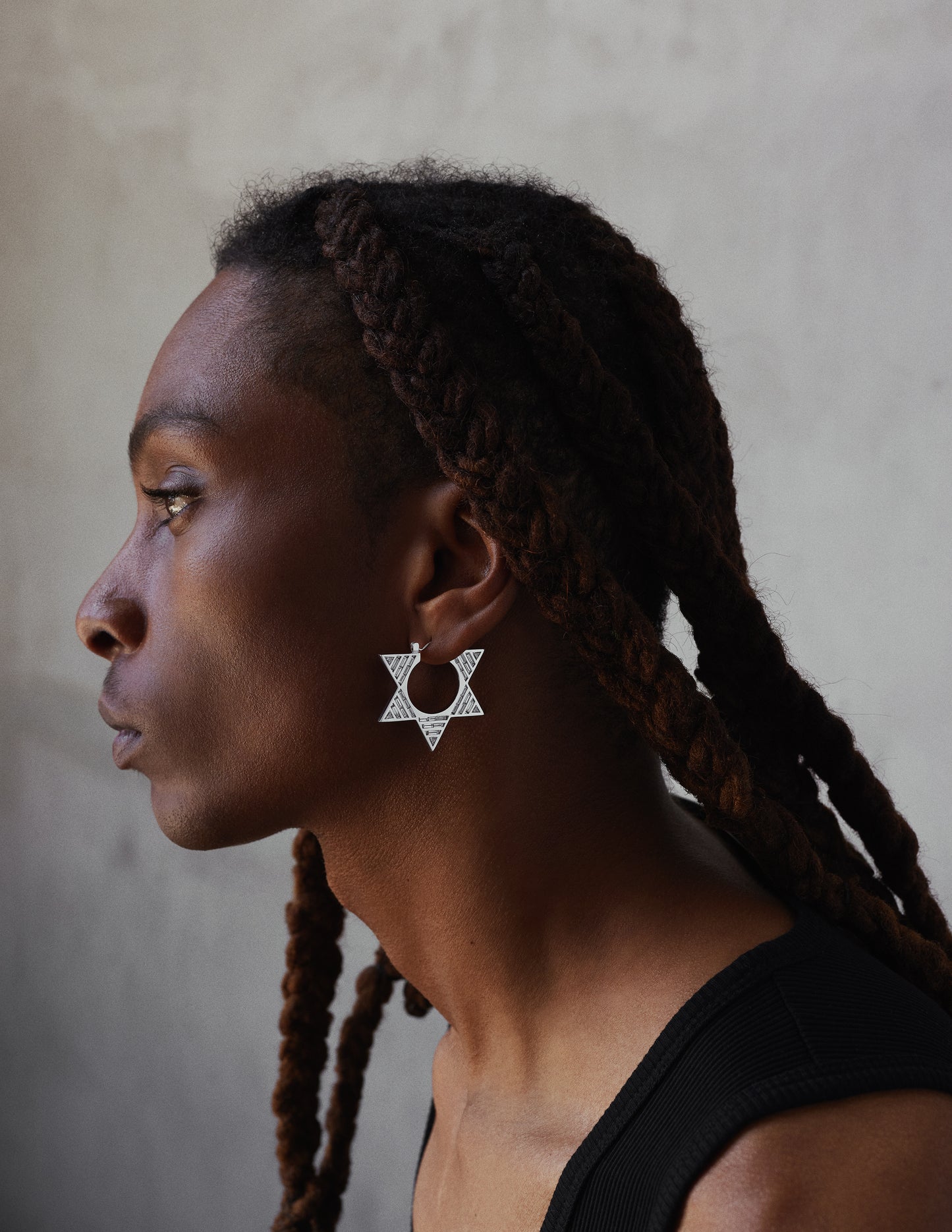 male model wearing double sided white gold hoops set with baguette diamonds