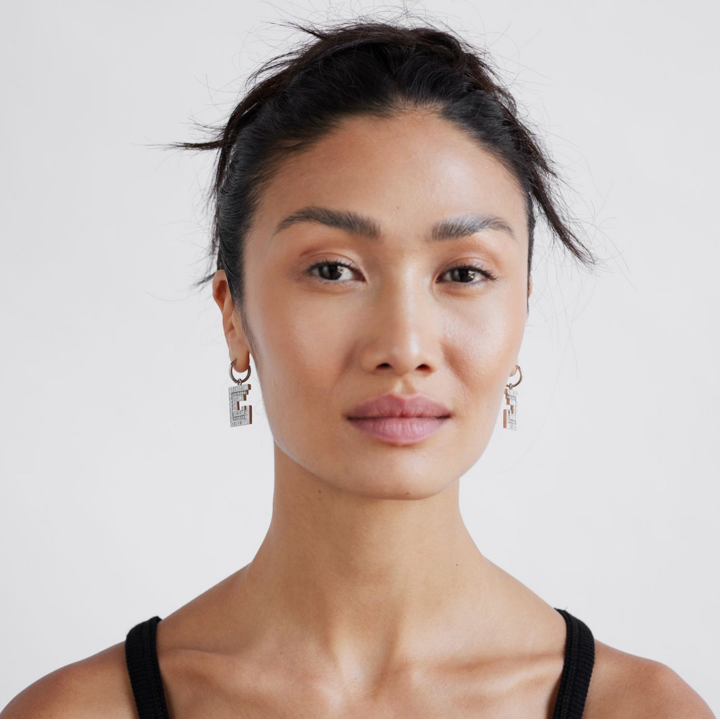 model wearing white gold and diamond earrings
