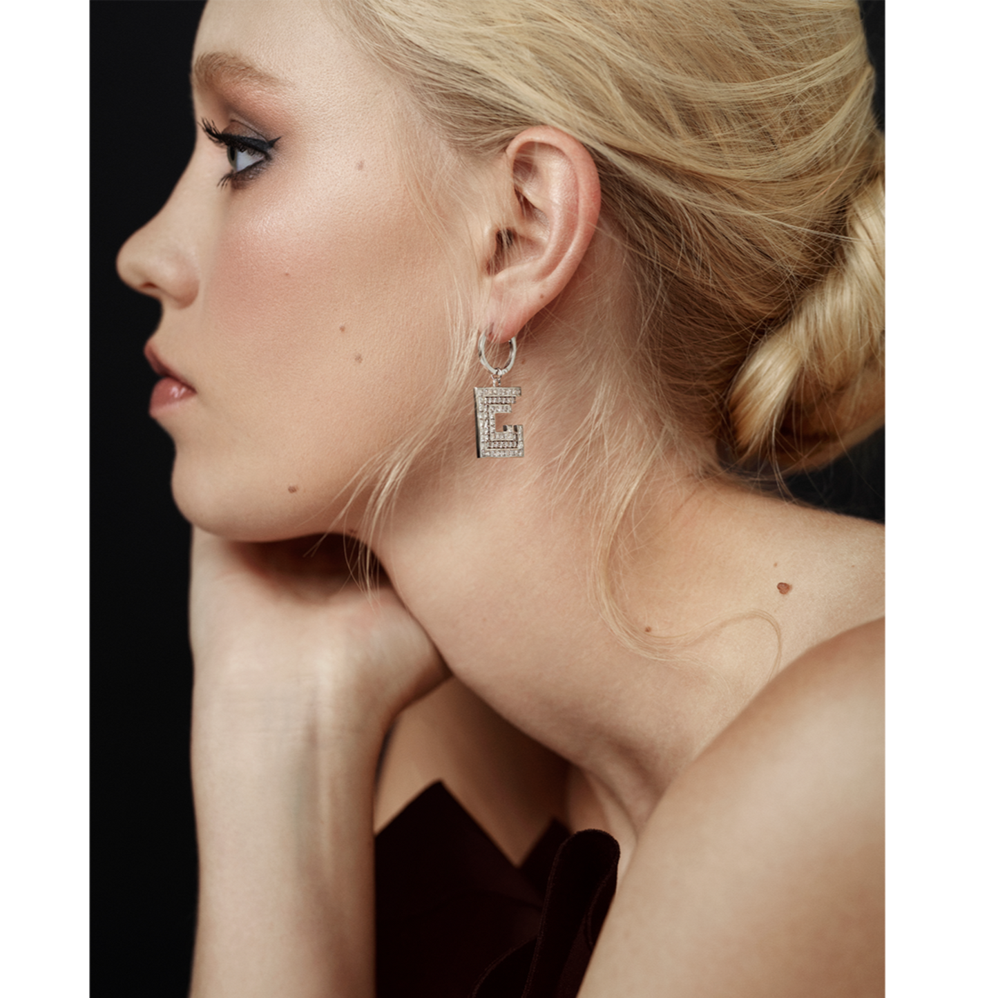 model wearing white gold and diamond spiral square earrings