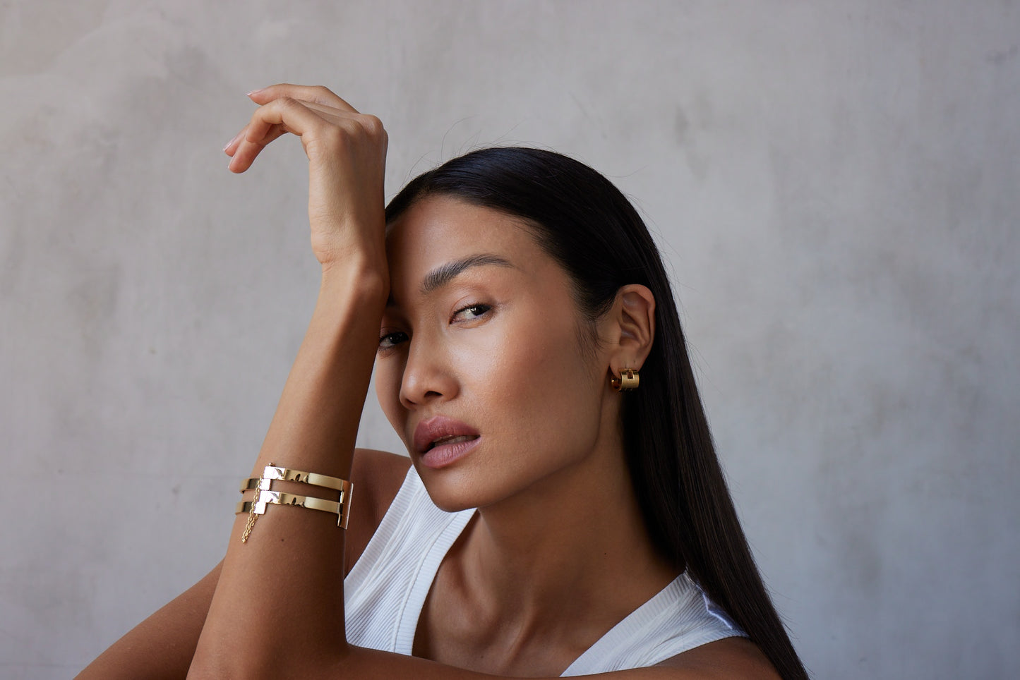 model wearing a multi-band gold cuff