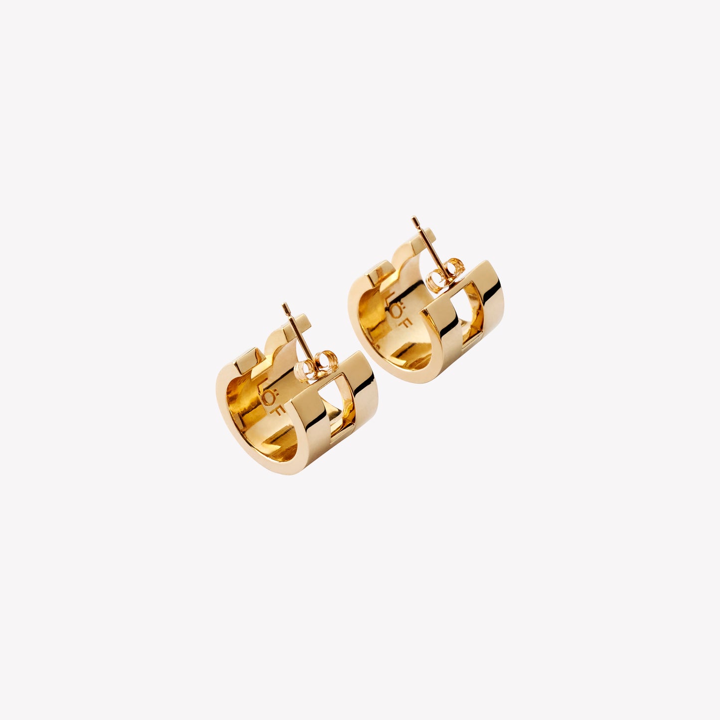 A pair of chunky gold hoop earrings with a geometric design, part of the Margueritte collection.