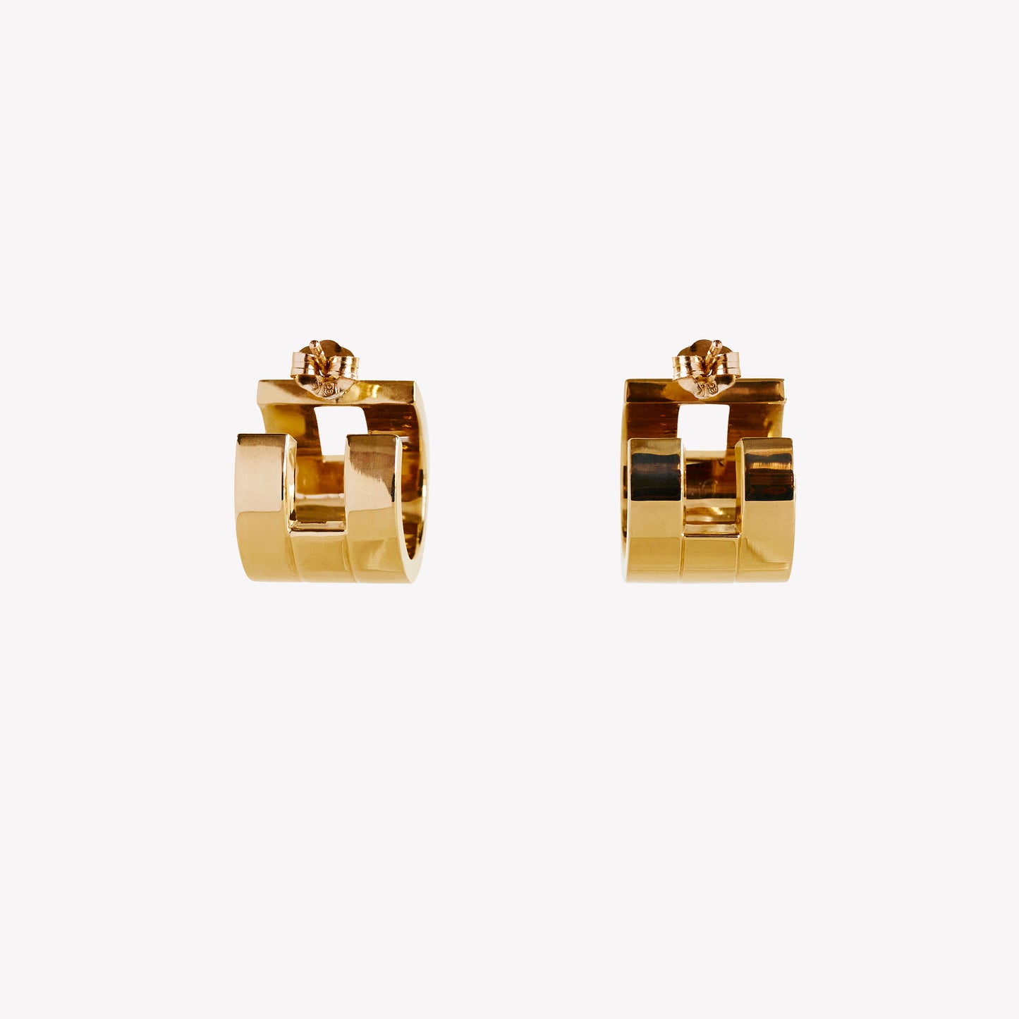 A pair of chunky gold hoop earrings with a geometric design, part of the Margueritte collection.