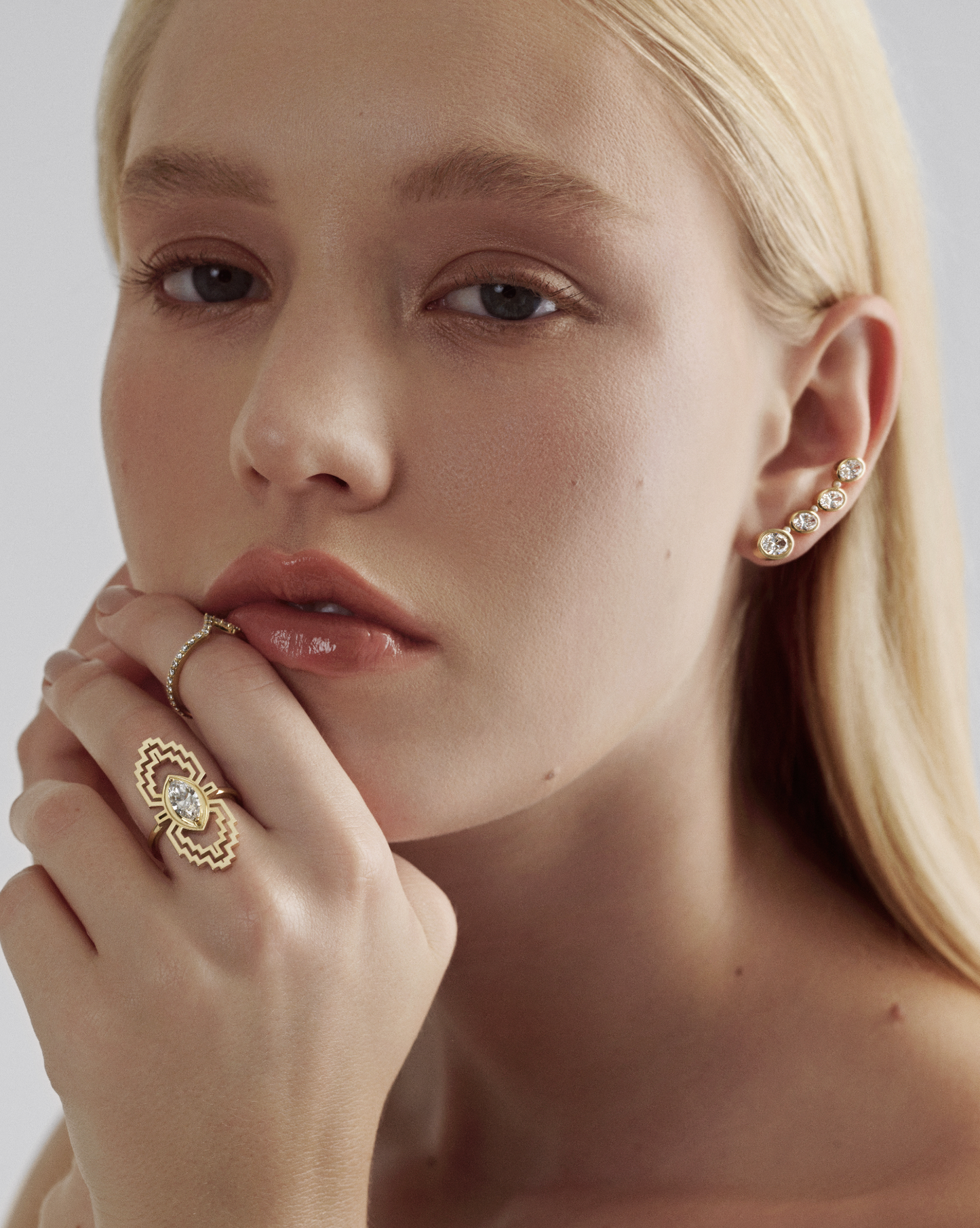 A female model wearing a marquise diamond ring