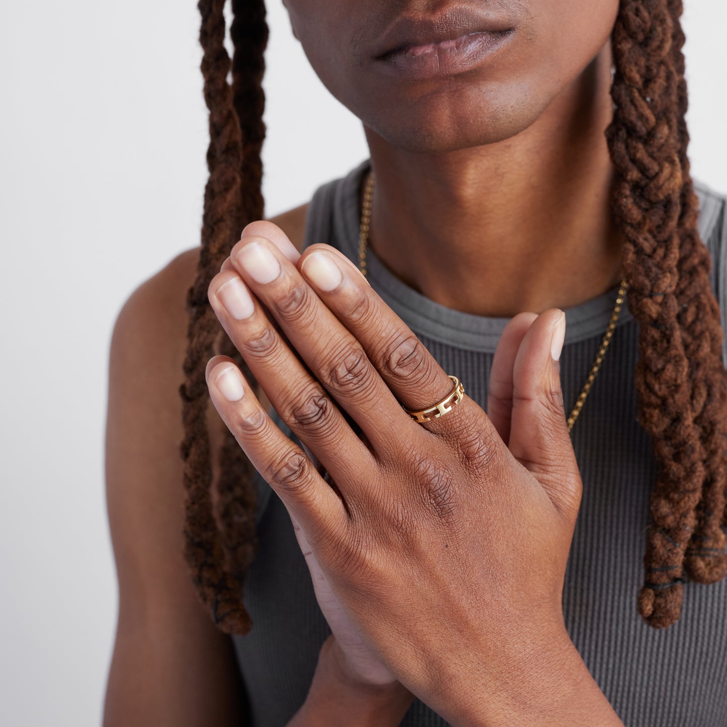 a male model wearing a gold laser cut ring