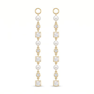A pair of gold drop earrings featuring white pearls, square pearl-like beads, and old european cut diamonds, shown on a plain white background.