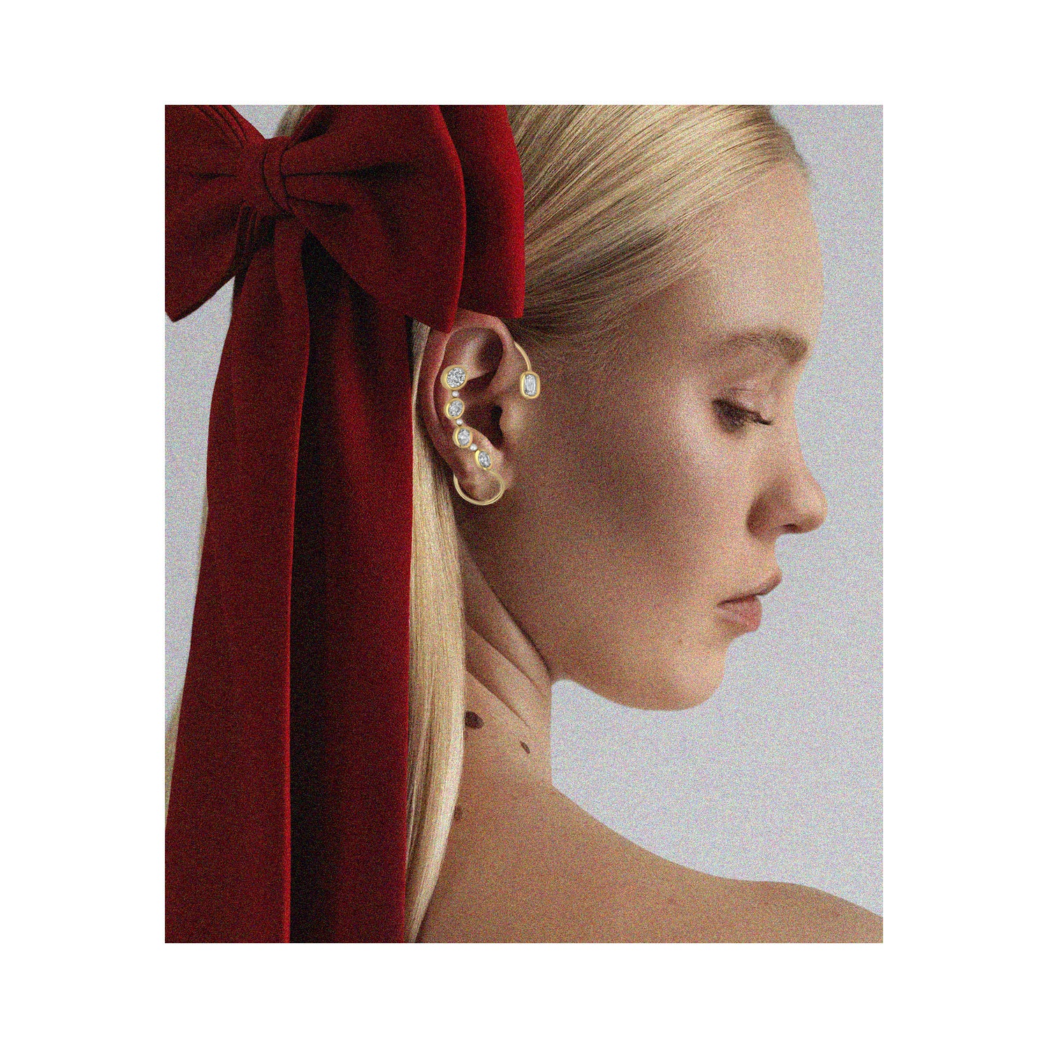 Female model wearing vendome ear cuffs with yellow gold diamonds and pearls