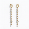 A pair of gold dangle earrings with white pearls, clear round diamonds, and white square shell-like beads, displayed on a clean white background.