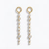 A pair of gold dangle earrings with whitenatural pearls, white square inlays, and old european cut diamond accents, shown on a clean white background.