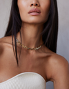 a female model wearing an 18k Gold chain link necklace on a white background