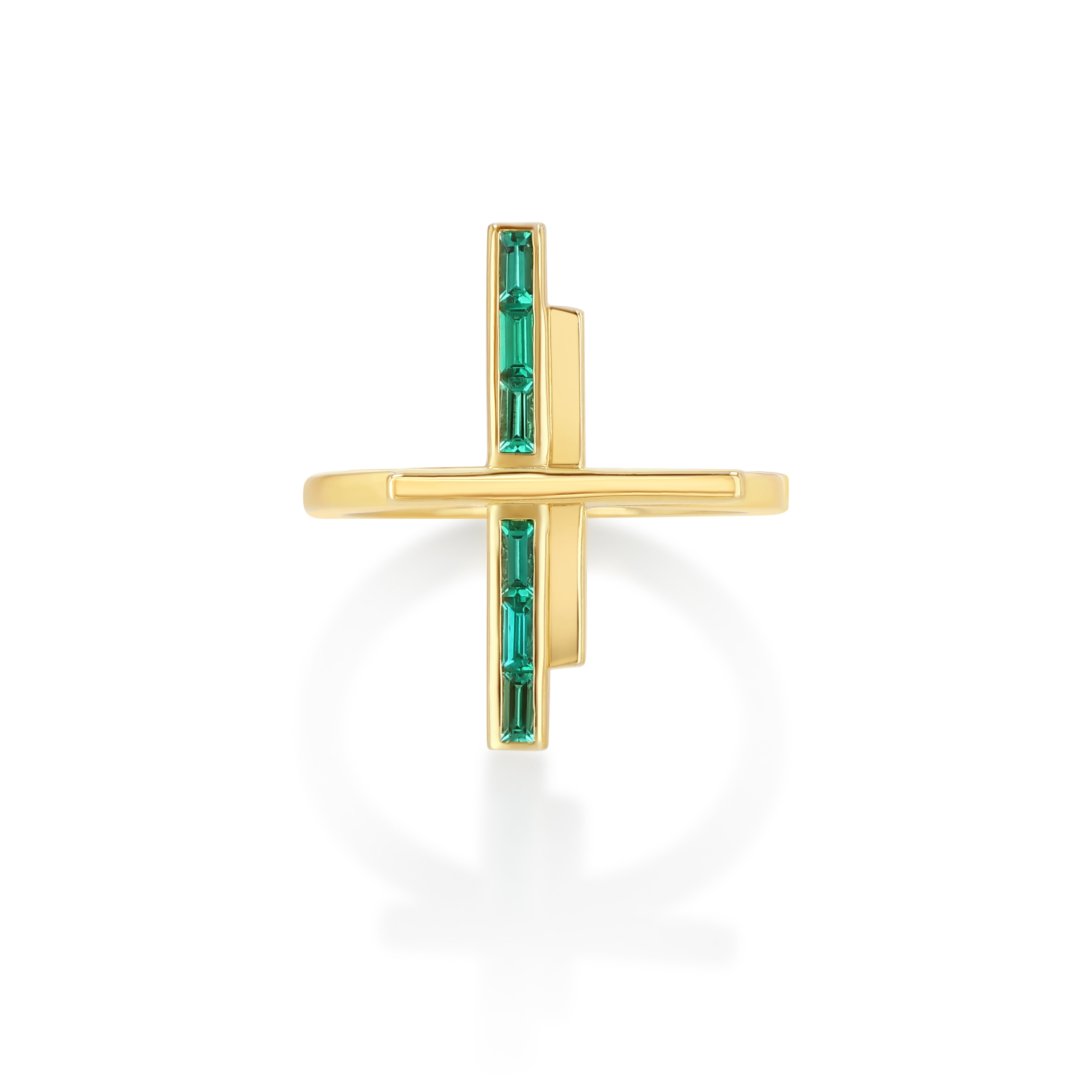 A gold ring with a geometric design featuring two vertical polished gold bars and one horizontal bar set with baguette cut emeralds.