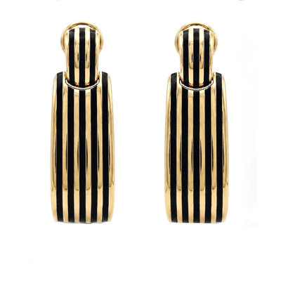 Gold and black striped earrings on a white background