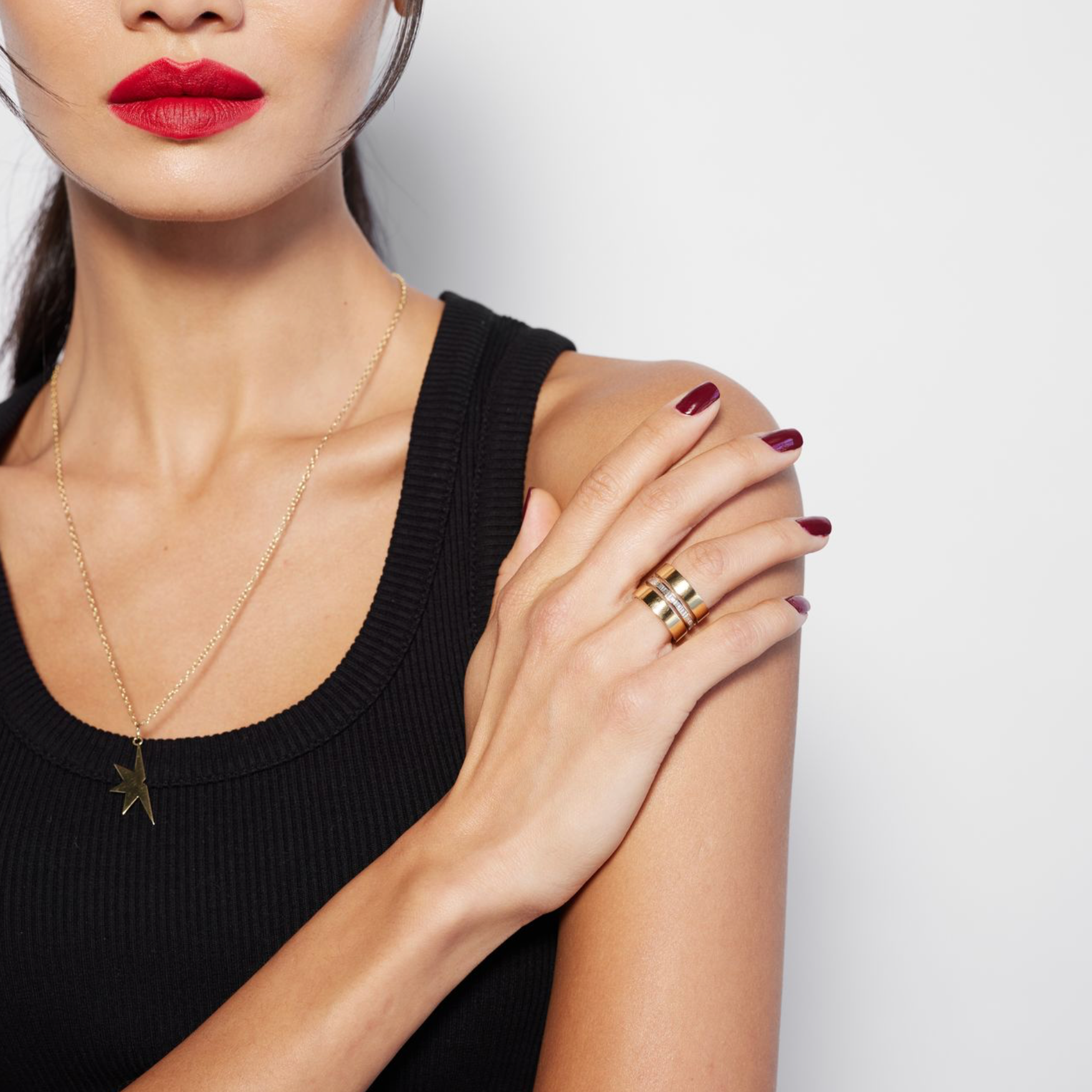 female model wearing gold triple band ring