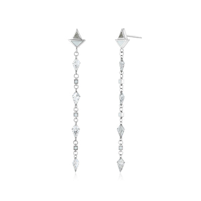 A pair of white gold earrings featuring kite-shaped white diamonds and white enamel details.
