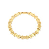 A gold bracelet with a chain of linked half-moon crescent shapes, crafted in an Art Deco style.
