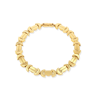 A gold bracelet with a chain of linked half-moon crescent shapes, crafted in an Art Deco style.