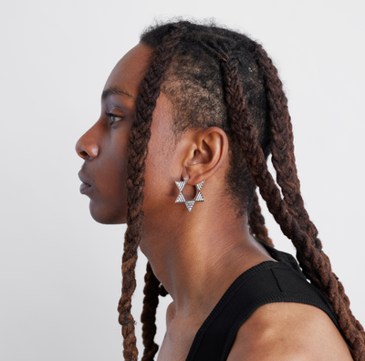 male model wearing double sided white gold and diamond hoops