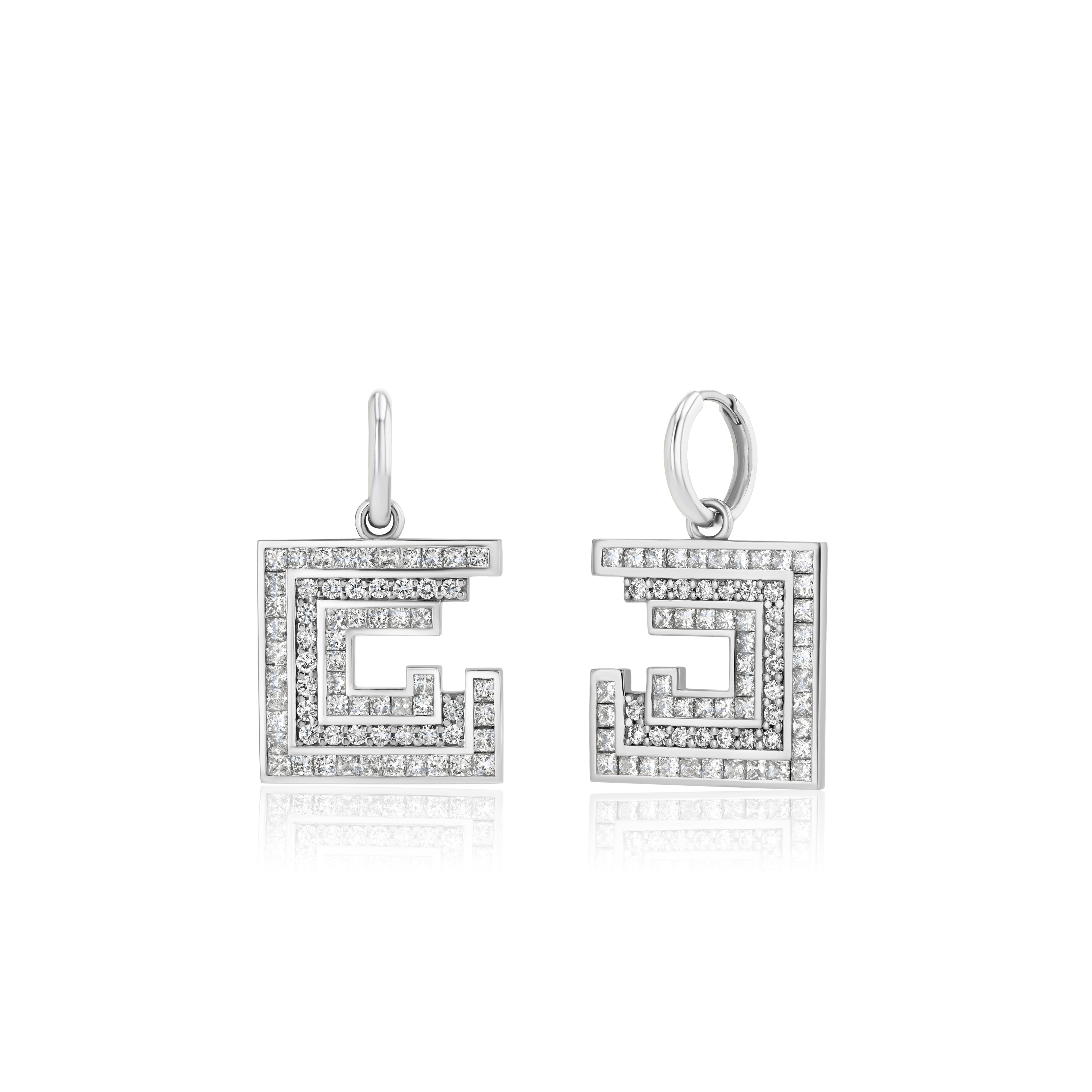 Pair of square-shaped white gold earrings with diamonds on a white background