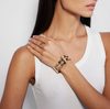 model wearing a multi band gold cuff with a vintage pin clasp