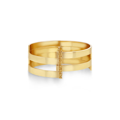 A handcrafted 18k recycled gold cuff bracelet with a unique delicate pin and chain clasp.