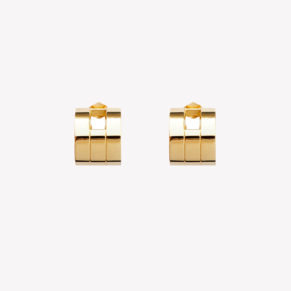 A pair of chunky gold hoop earrings with a geometric design, part of the Margueritte collection.