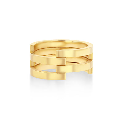 A stacked gold ring with a series of horizontal bands creating a sculptural effect, positioned against a white background.