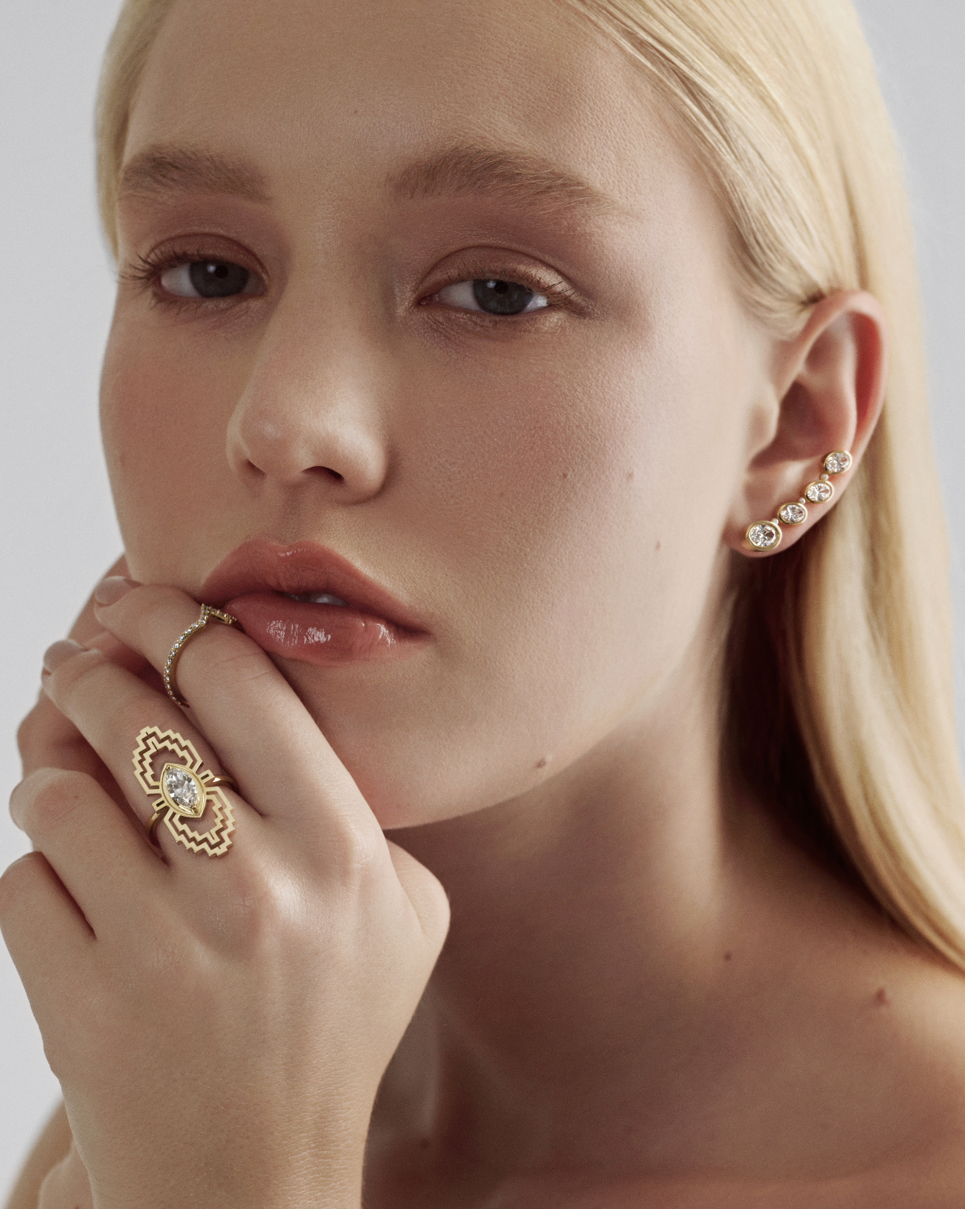 A female model wearing a marquise diamond ring
