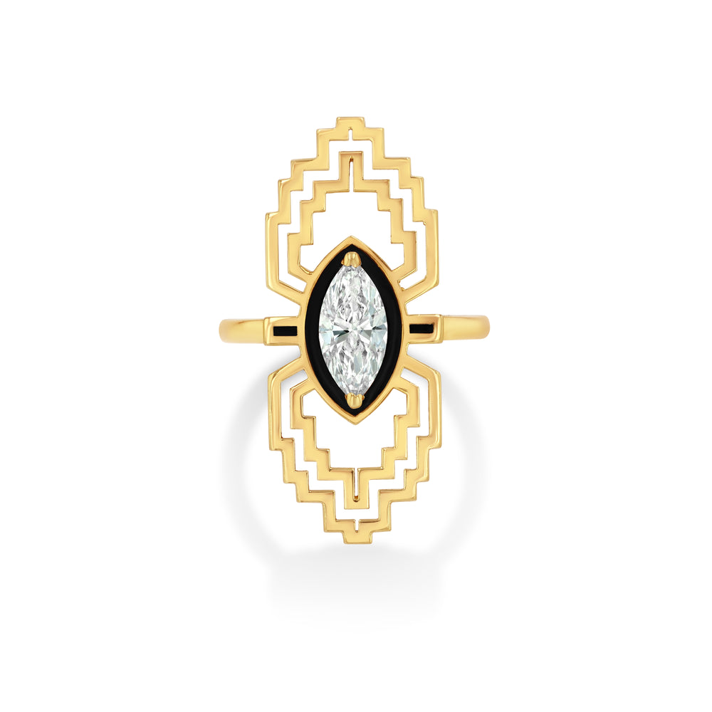 Gold art deco ring with a central gemstone on a white background