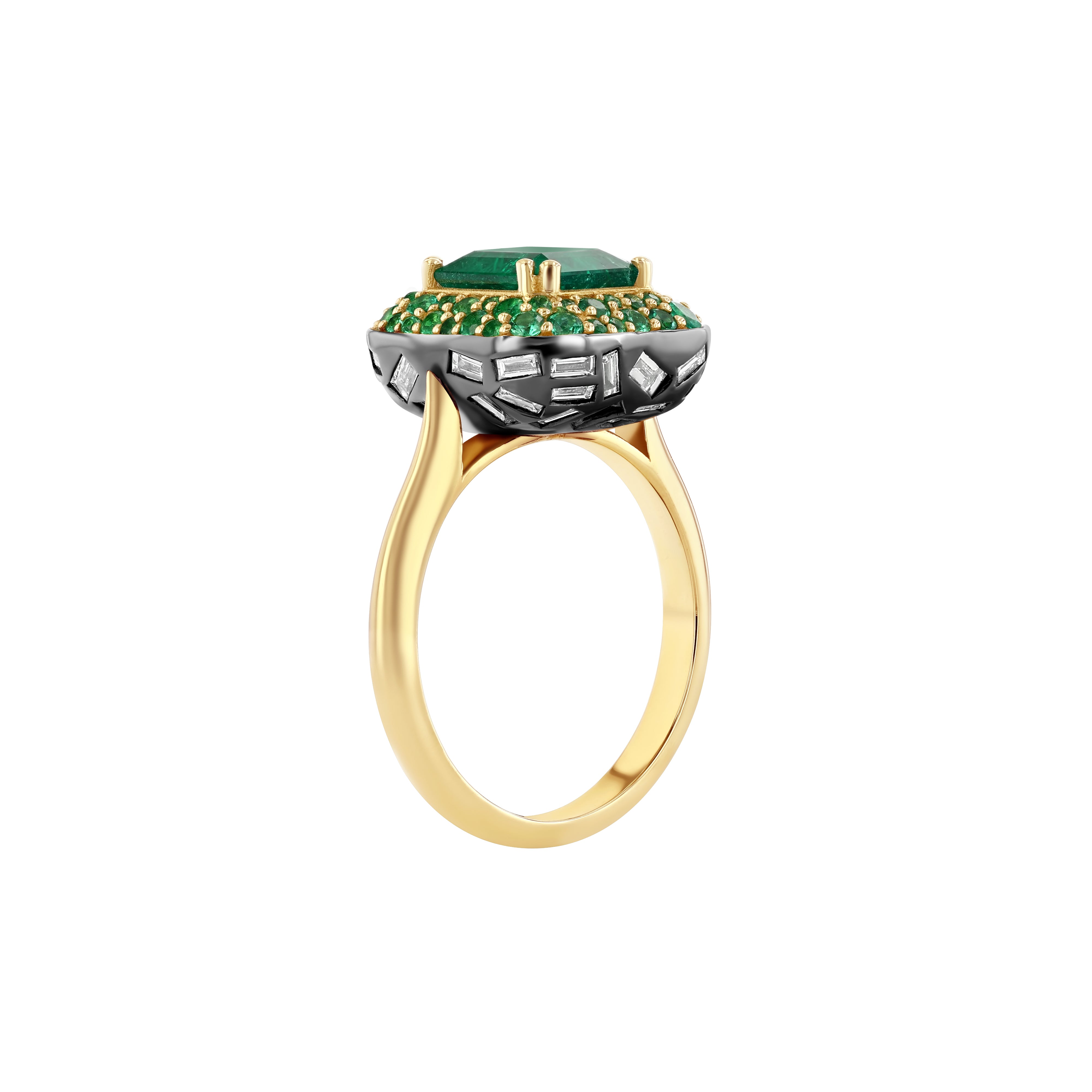 An elegant gold ring featuring an octagon cut Zambian natural 2ct emerald on a domed halo with pave emeralds and baguette natural diamonds set on the underside, with a 2mm band swooping up to ridged shoulders.