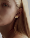a zigzag diamond and gold stud on a model close up