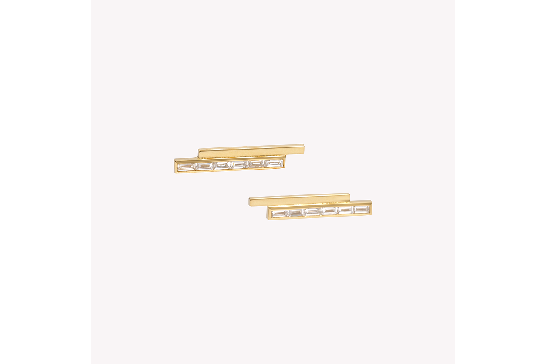 A pair of gold stud earrings with pinstripe bar design set with either diamonds or emeralds.