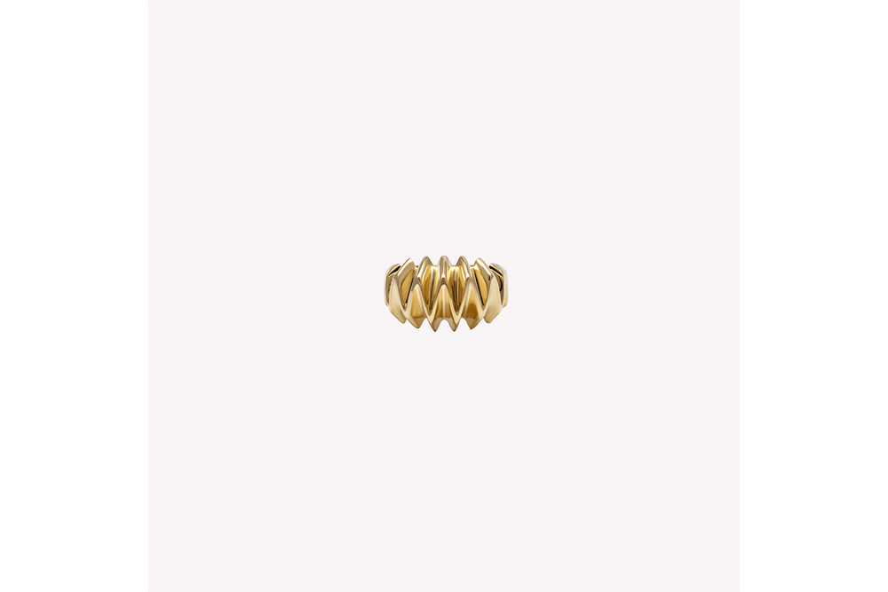 A textured, gold-colored pinky ring ring handcrafted in 18k recycled gold, displayed against a white background.