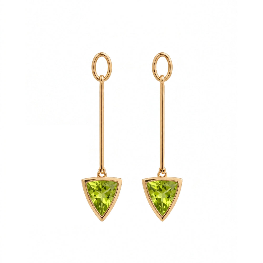 A pair of gold drop earrings featuring a triangular green gemstone pendant, set against a plain white background.